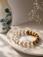 Close-up of Agarwood beads and golden inclusions in Super Seven Quartz
